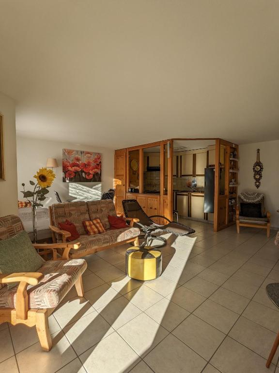 a large living room with couches and a kitchen at Apartment Above the Rooftops - Mountain Panorama in Naters