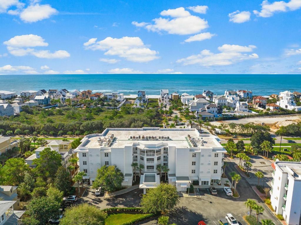 an aerial view of a white building and the ocean at The Alexander in Rosemary Beach