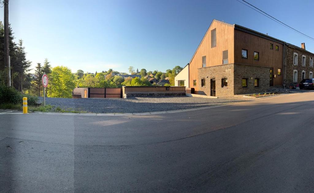 an empty street in front of a brick building at MontHuit in Houffalize