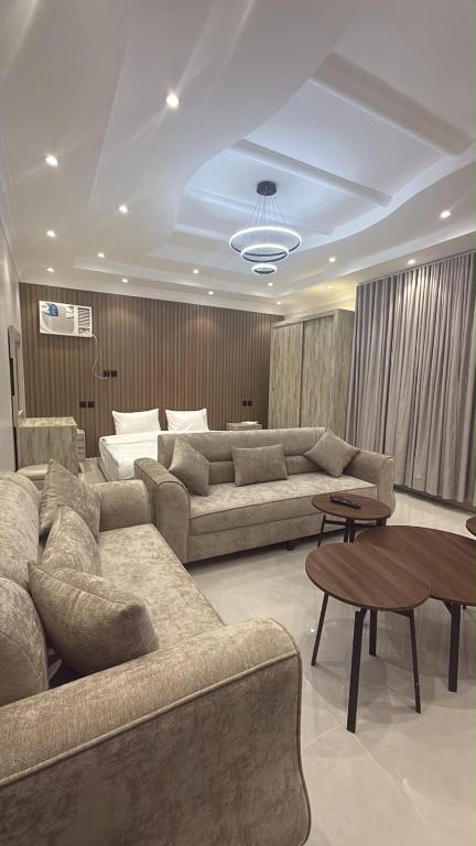 a living room with two couches and a table at شقة سحاب ابها in Abha