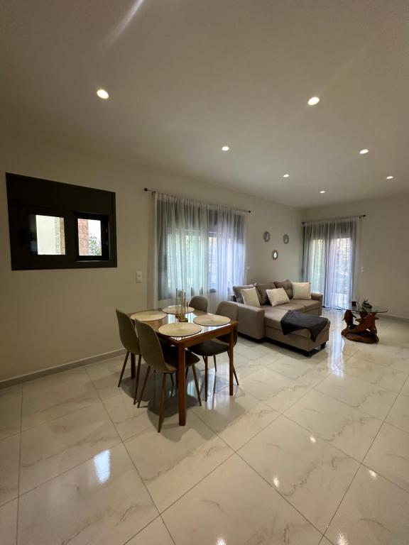 a living room with a couch and a table at Eleonora apartment in Porto Rafti