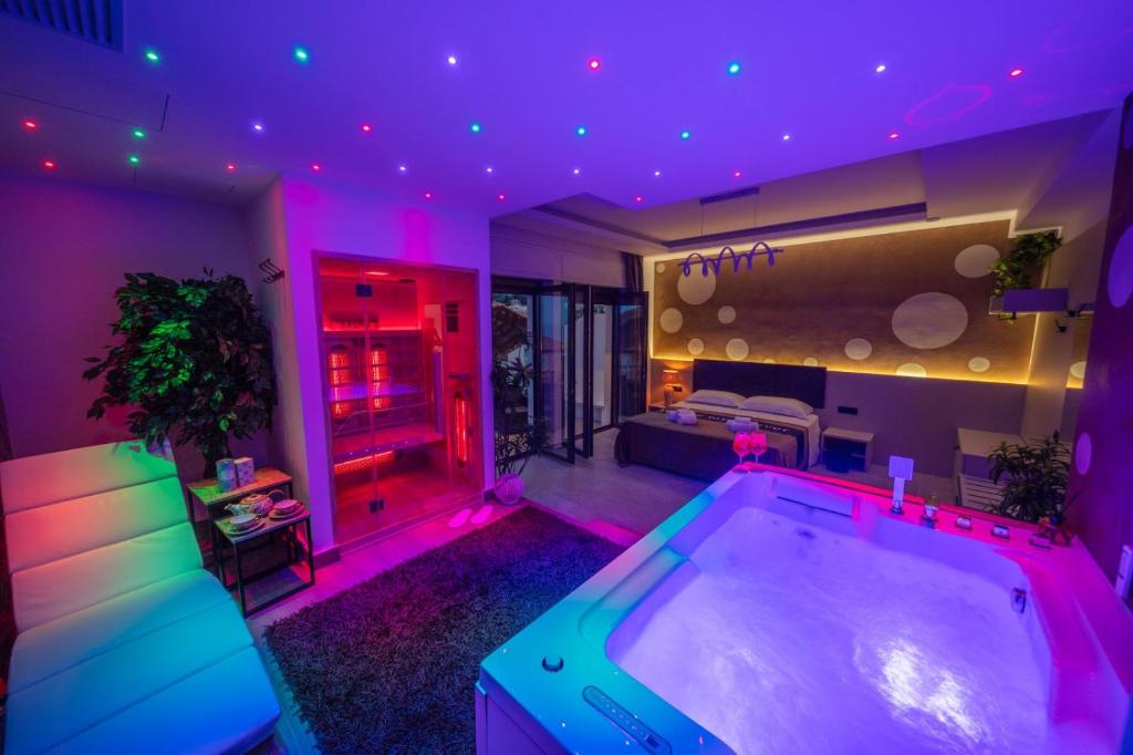 a large tub in a room with purple lighting at Suite Apartment Taormina in Taormina