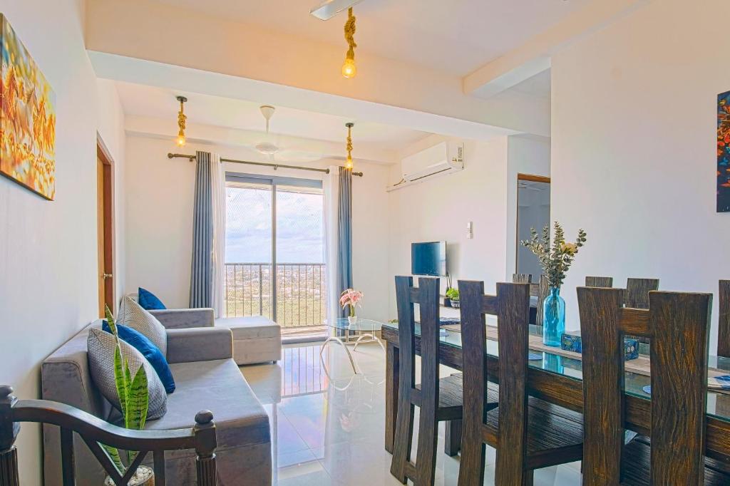 a dining room and living room with a table and chairs at Lovish luxury villa in Colombo