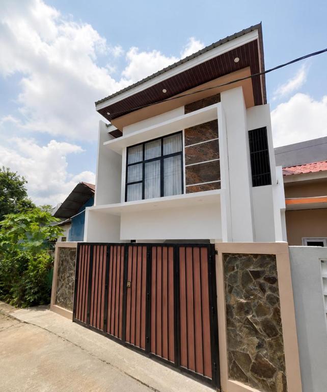 a house with a gate in front of it at Nameera house in Makassar