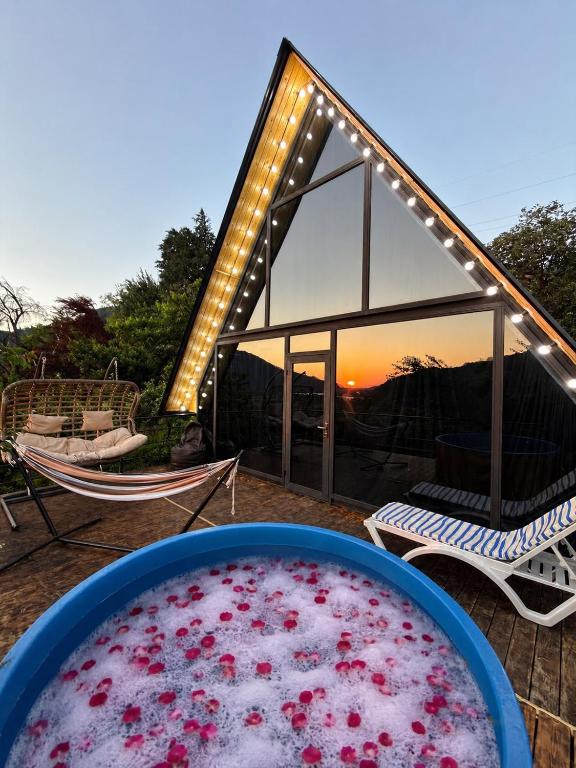 a large pool of red water in front of a house at Panorama Cottage in Erge