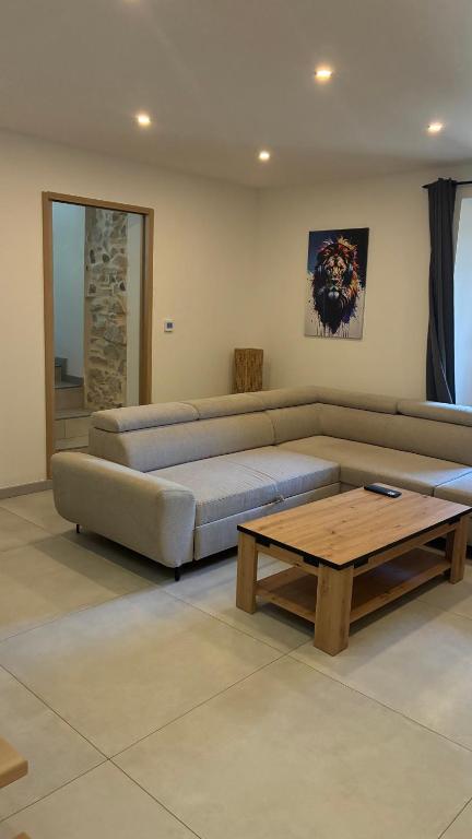 a living room with a couch and a coffee table at maisonnette in Menglon