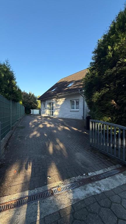 a house with a fence in front of a driveway at Private Home in Hamburg in Hamburg