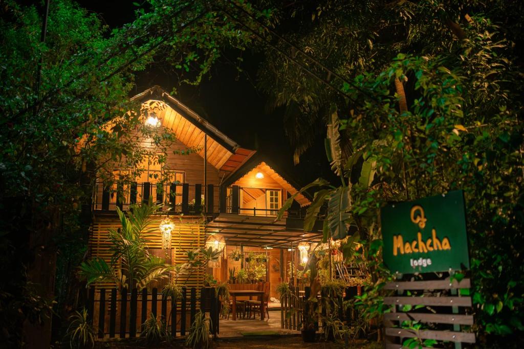 a house with a sign in front of it at night at Machcha Lodge Sigiriya in Sigiriya