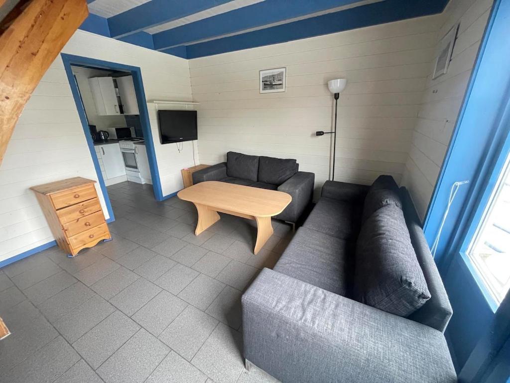 a living room with a couch and a table at Nautnes Costal Heaven in Nautnes