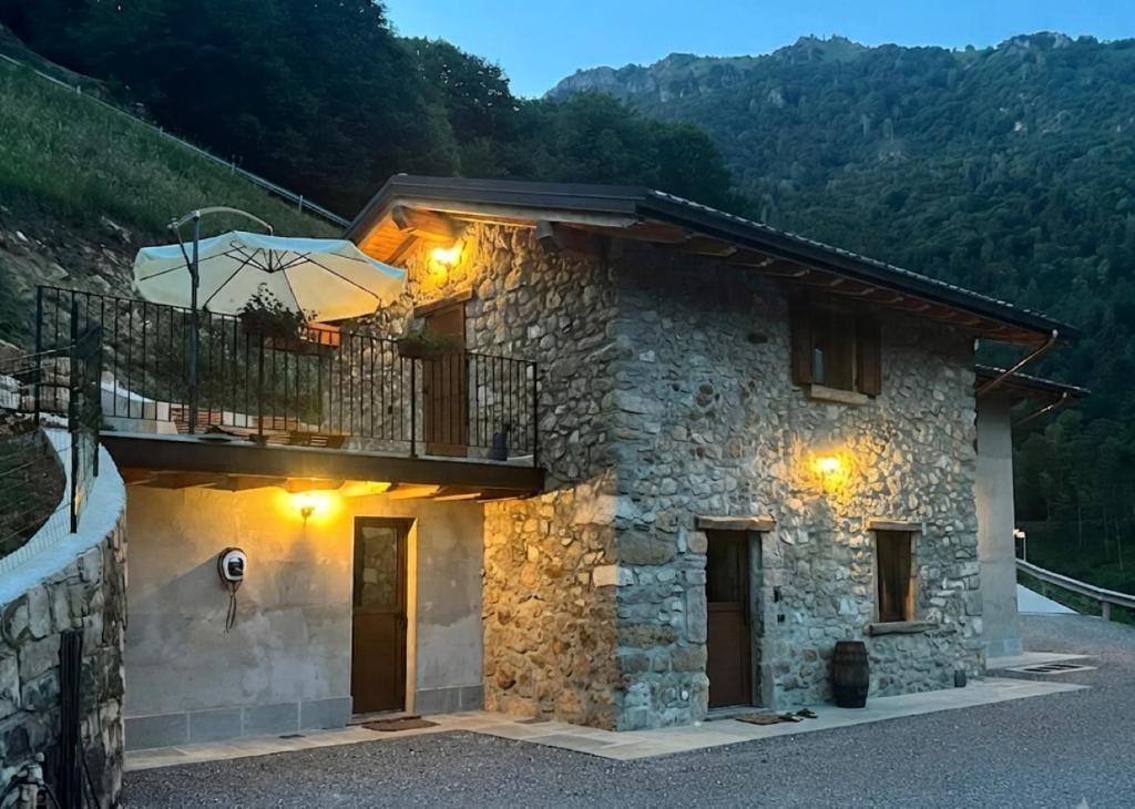 ein Steinhaus mit einem Balkon an der Seite in der Unterkunft Angel Chalet in Serina