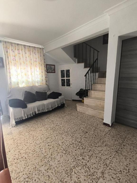 a bedroom with a bed and a staircase at Casa la parra in Ardales