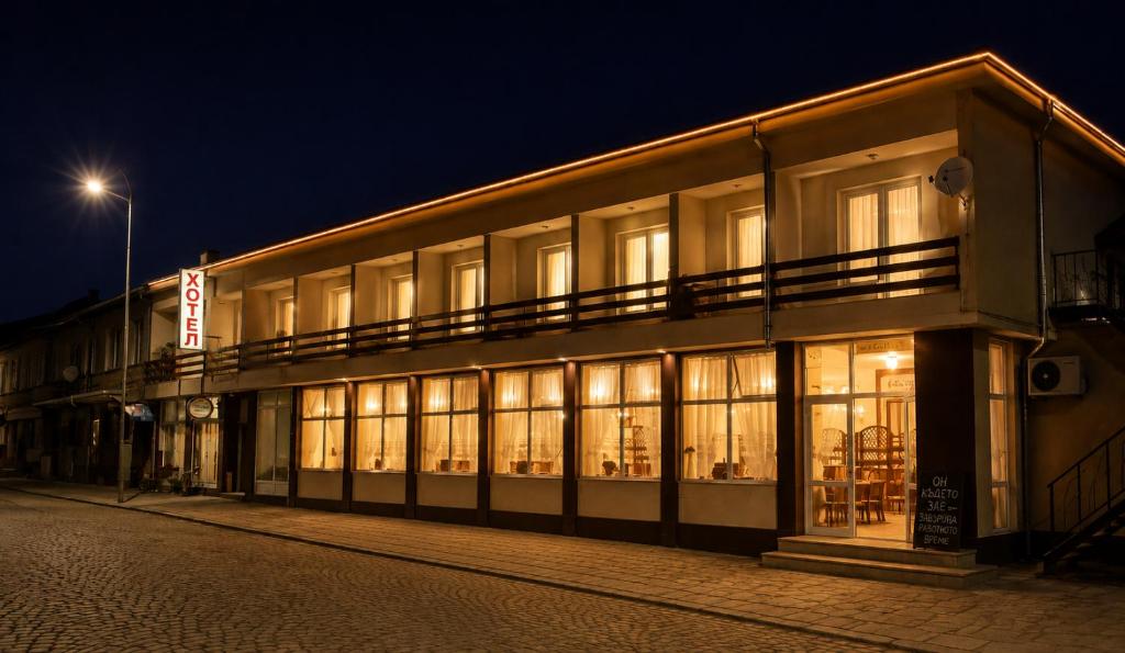 a building at night with lights in the windows at Семеен Хотел ,,Царева Ливада'' in Tsareva Livada
