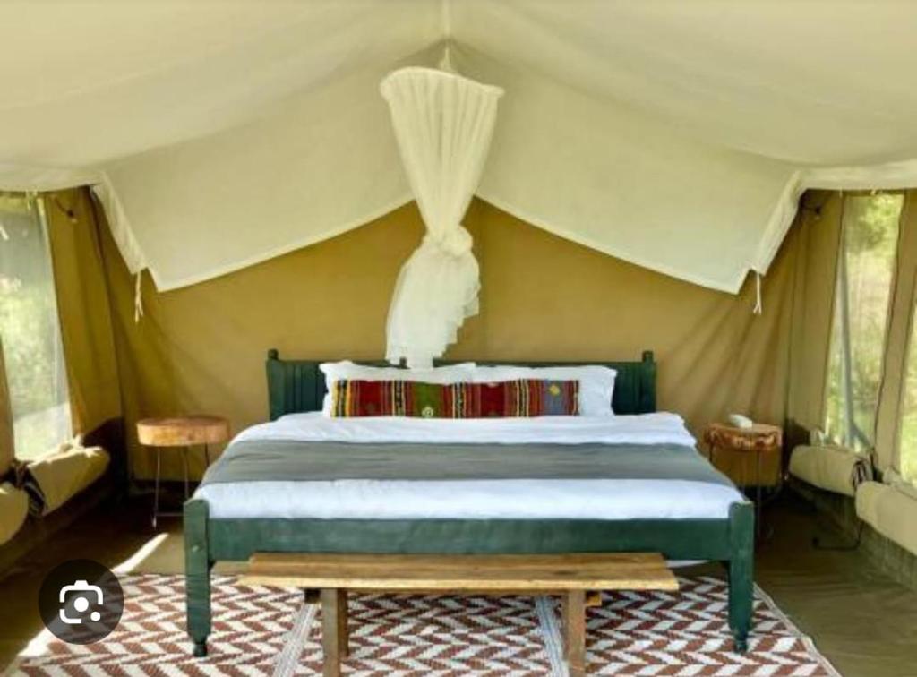 a bedroom with a bed in a tent at Olopiro Stay in Maasai Mara National Reserve