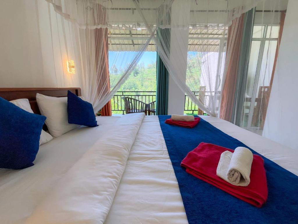 a bedroom with a large bed with towels on it at Tea Pick View Ella in Ella