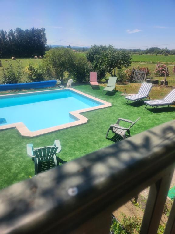 a swimming pool with chaise lounge chairs at Mas de Grezes in Gaillac