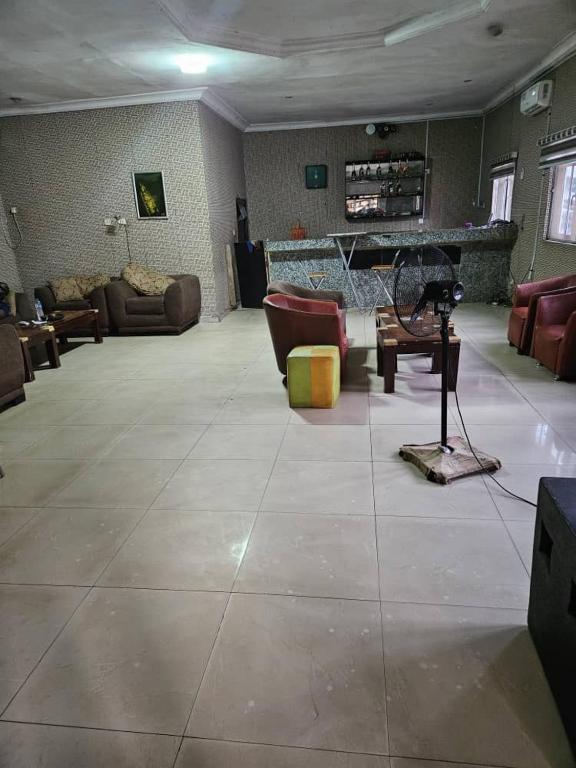 a large living room with couches and a piano at GRACECUT HOTEl in Enugu
