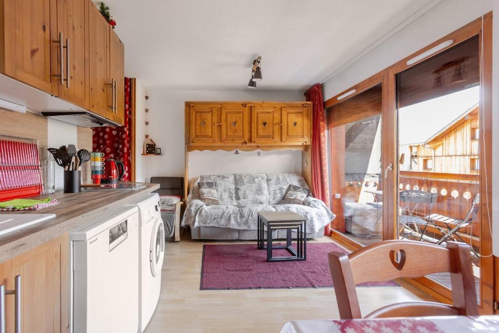 a kitchen with a bed in the middle of a room at Appartement T2 Chalets Superd in Le Dévoluy