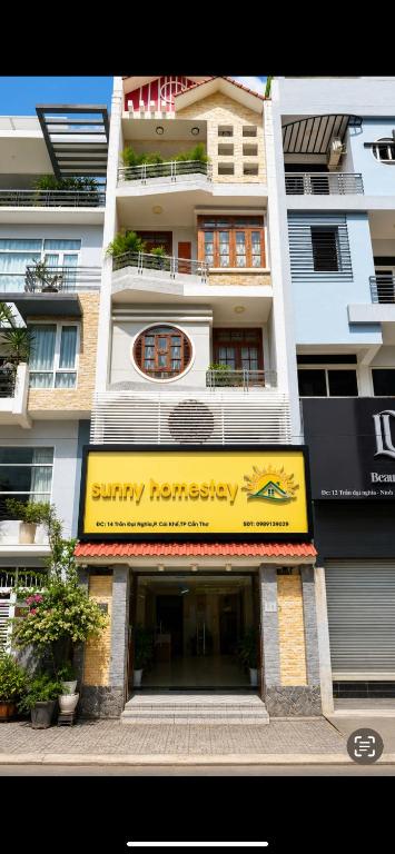 a building with a sign for a swimming franchise at Sunny Homestay Cần Thơ in Can Tho