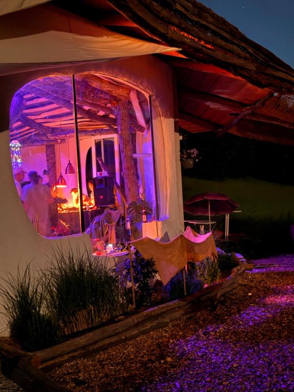 a house with purple lights in a yard at EinBaumHaus Wörthersee in Auen