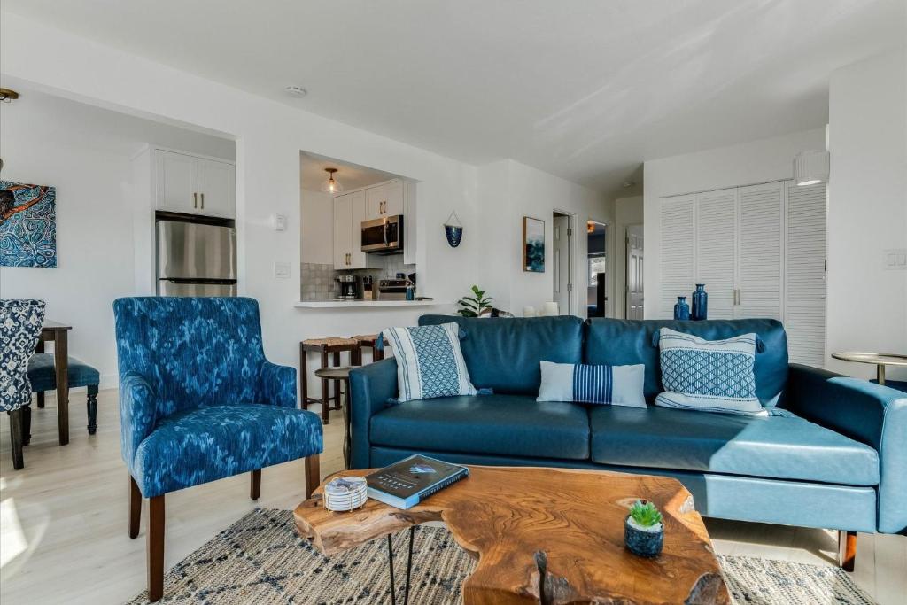 a living room with a blue couch and a table at Bella Blu in Avila Beach