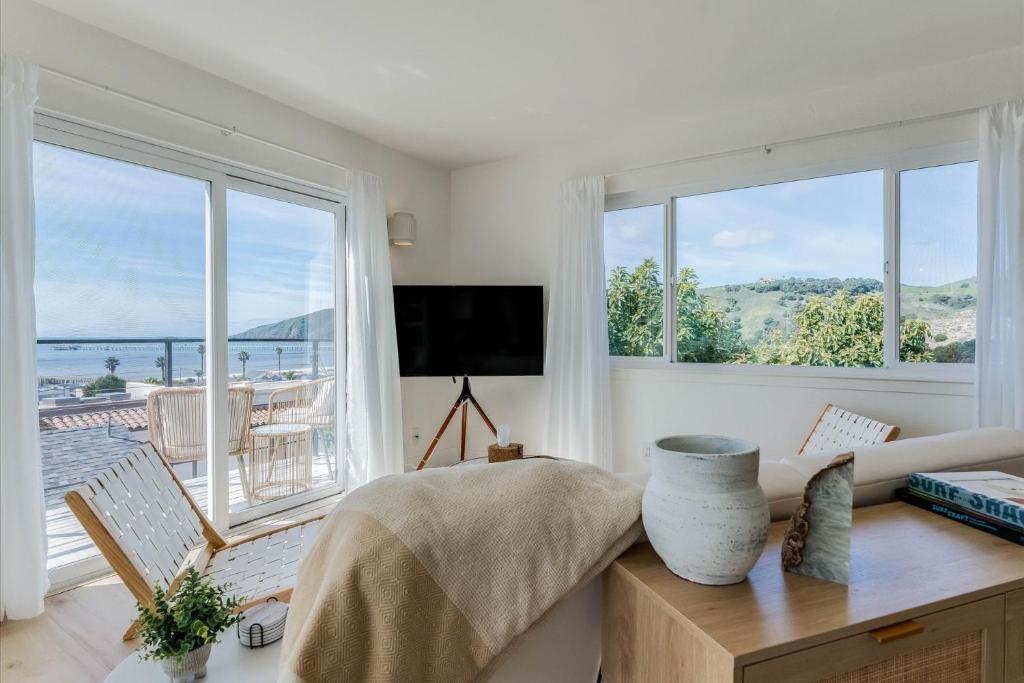 a living room with a couch and a large window at Bella Surf in Avila Beach