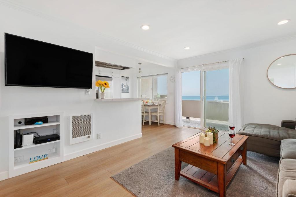 a living room with a flat screen tv on a wall at Carpinteria Shores CS 209 in Carpinteria