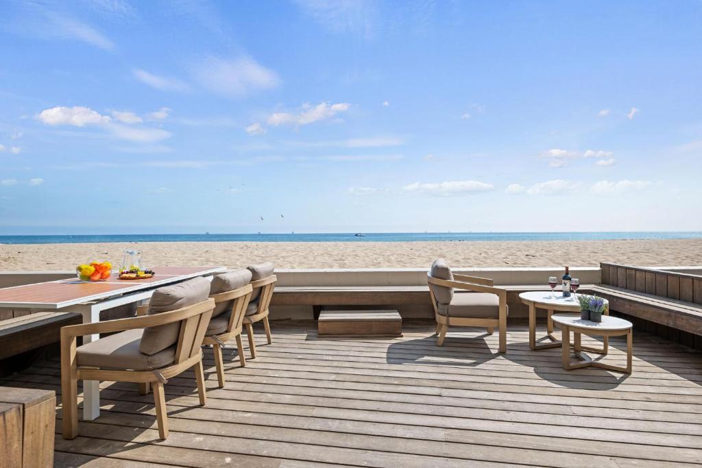 a wooden deck with tables and chairs on the beach at Carpinteria Shores CS 109 in Carpinteria