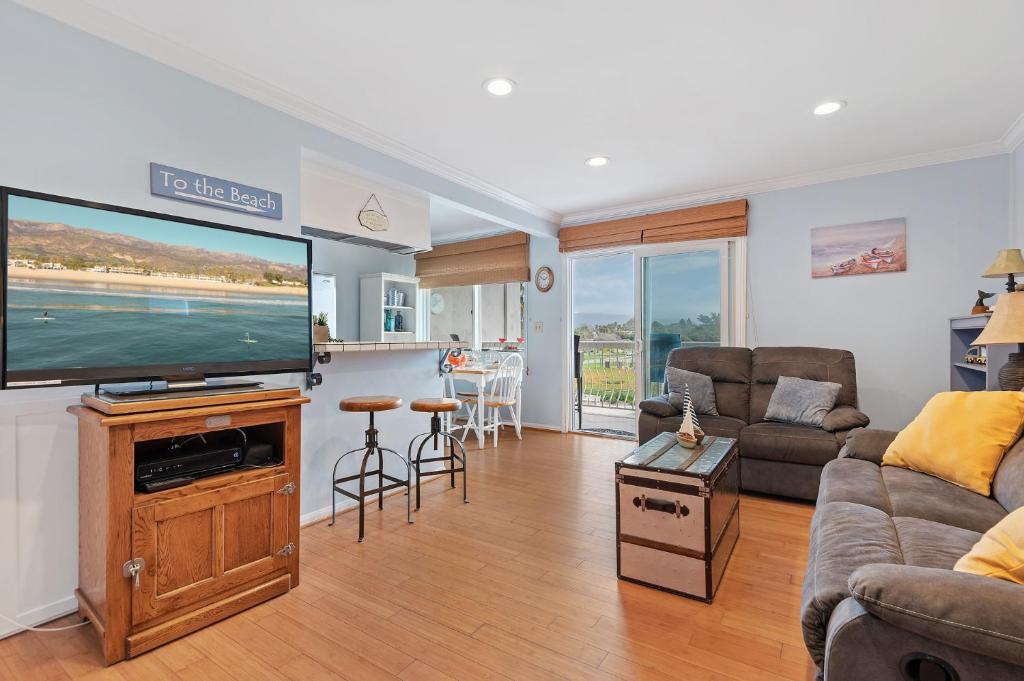 a living room with a large flat screen tv at Carpinteria Shores CS 302 in Carpinteria