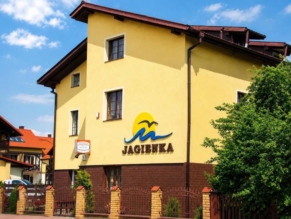a building with a sign on the side of it at Jagienka in Łeba