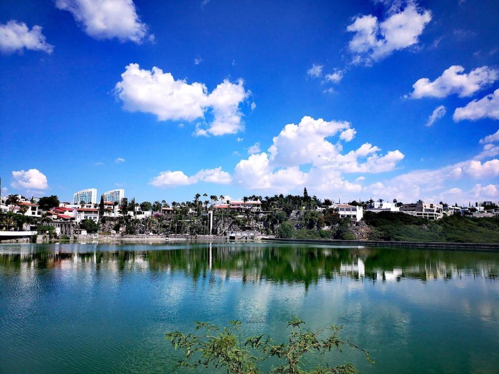 a large body of water with a city in the background at Lake side Luxury Duplex ! in Jurica