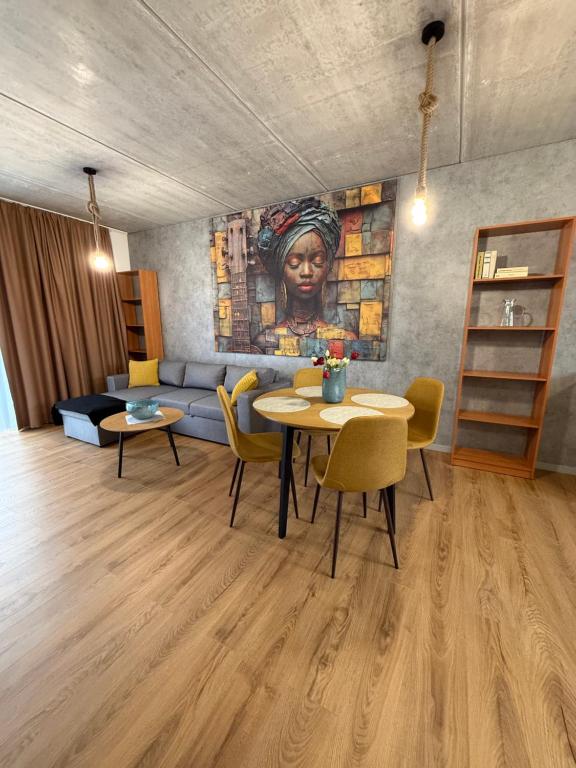 a living room with a couch and a table with chairs at Diamond Houses in Námestovo