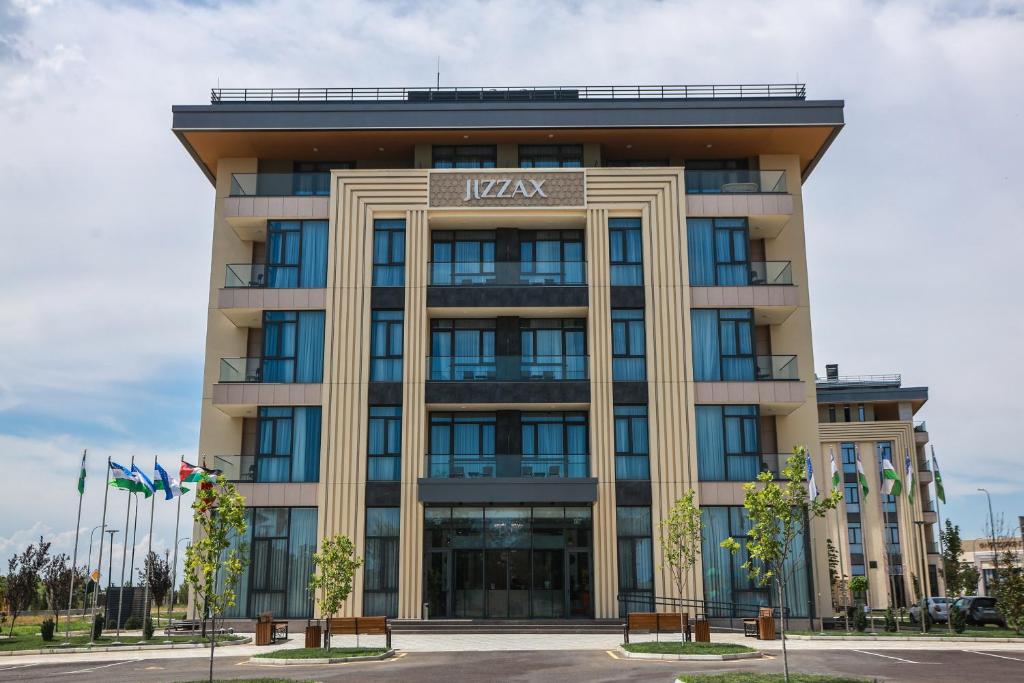 an office building with the name of the hotel at Jizzax Hotel Tashkent in Tashkent