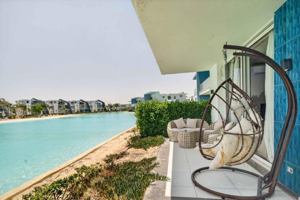 a bench on a balcony next to a swimming pool at Fouka Bay Holiday Apartments By BlueKeys in Marsa Matruh