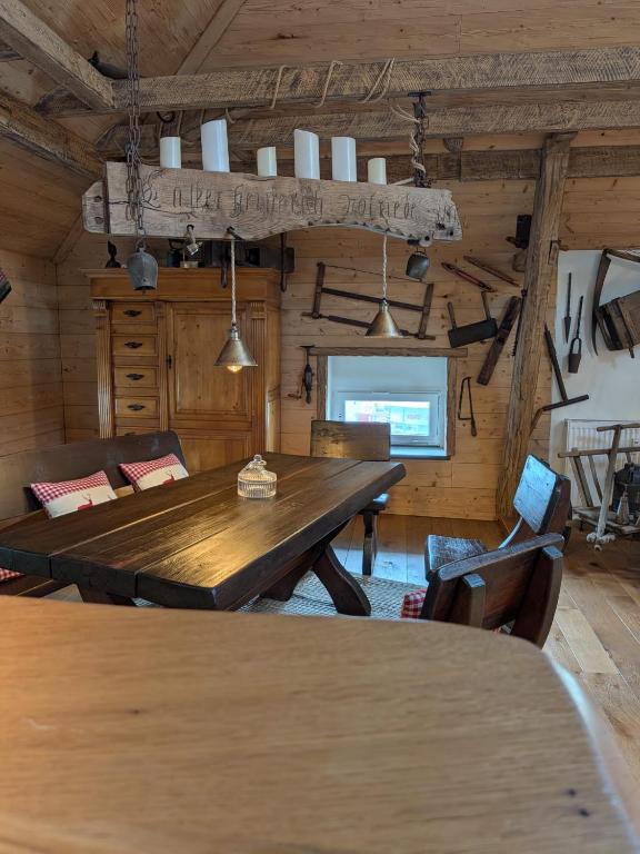 a dining room with a wooden table and chairs at Gästehaus LeLo 7 in Solingen