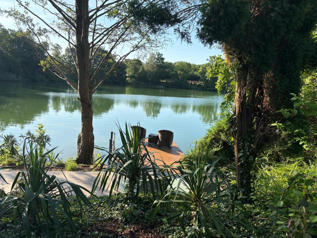 a view of a lake with a boat in it at Lake House Ternsche in Selm