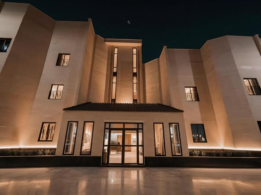 a large building at night with its doors open at شقق الإيجار - العروبه in Riyadh