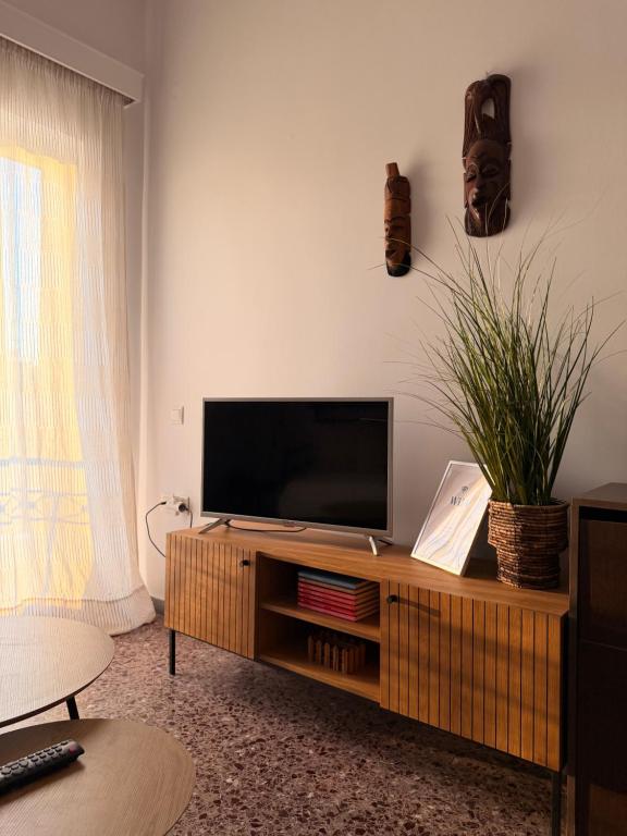 a living room with a flat screen tv on a table at KROKOS HOUSE in Aliveri
