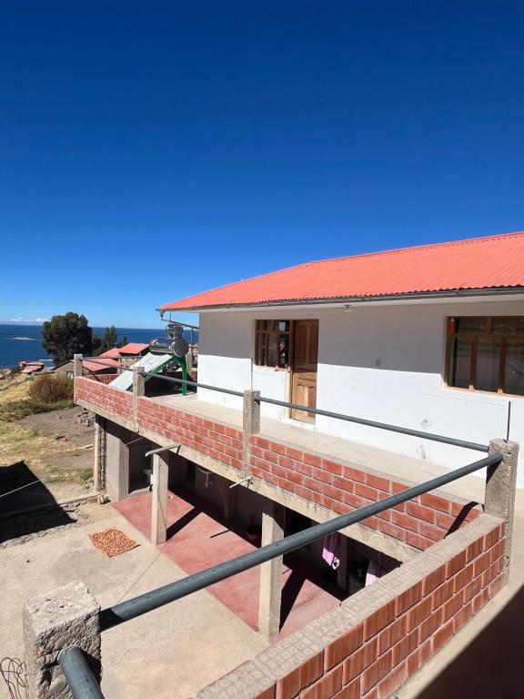 a view of a house from the balcony at Kusikuy Wasy Lodge in Puno