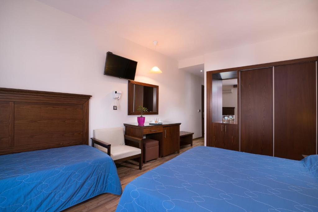 Postel nebo postele na pokoji v ubytování Hotel Olympion