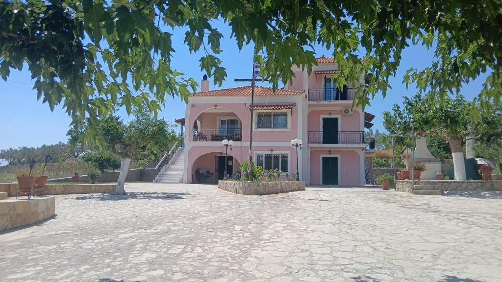 a large pink house with a large driveway at Dimelia Heaven Farm in Kranidi
