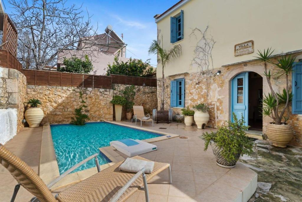a swimming pool in front of a house at Villa Epavlis in Plaka
