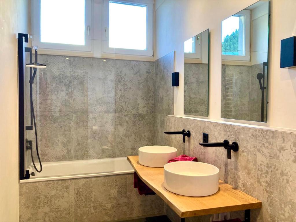 a bathroom with two sinks and a shower at Chasa Sot-Chaunt 301 in Samnaun