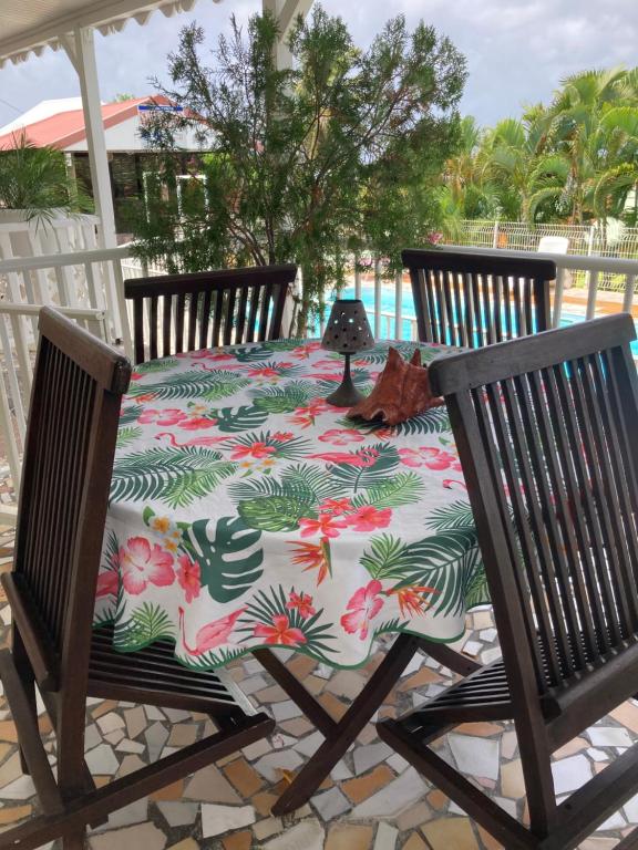 a table with a flowered table cloth on a patio at LE VILLAGE DE CANADA in Faup