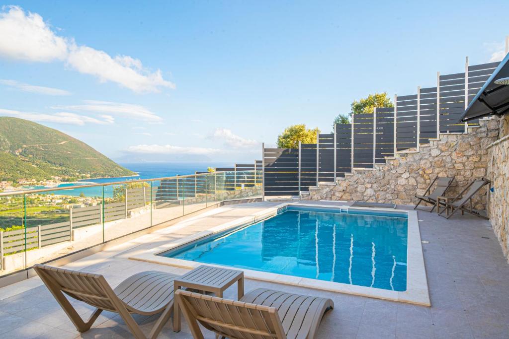 a swimming pool on a balcony with a view of the ocean at Aifantis Villa 1 in Póndi