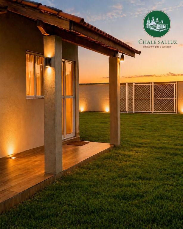 a view of a house with a wooden deck at Chalé Romântico Privativo com Lareira e vista para Montanhas in Capela do Alto