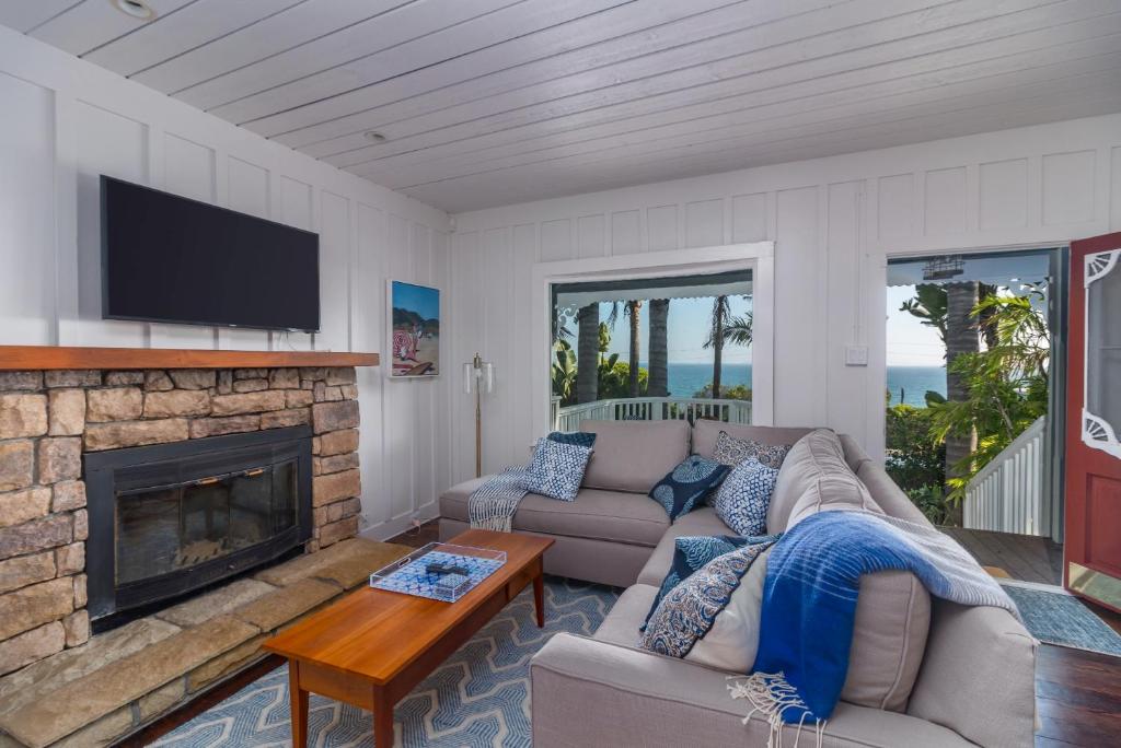 a living room with a couch and a fireplace at Lillie by the Sea in Summerland