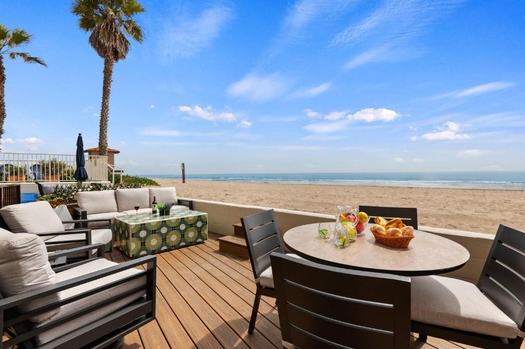 a patio with a table and chairs on the beach at Carpinteria Shores CS 105 in Carpinteria