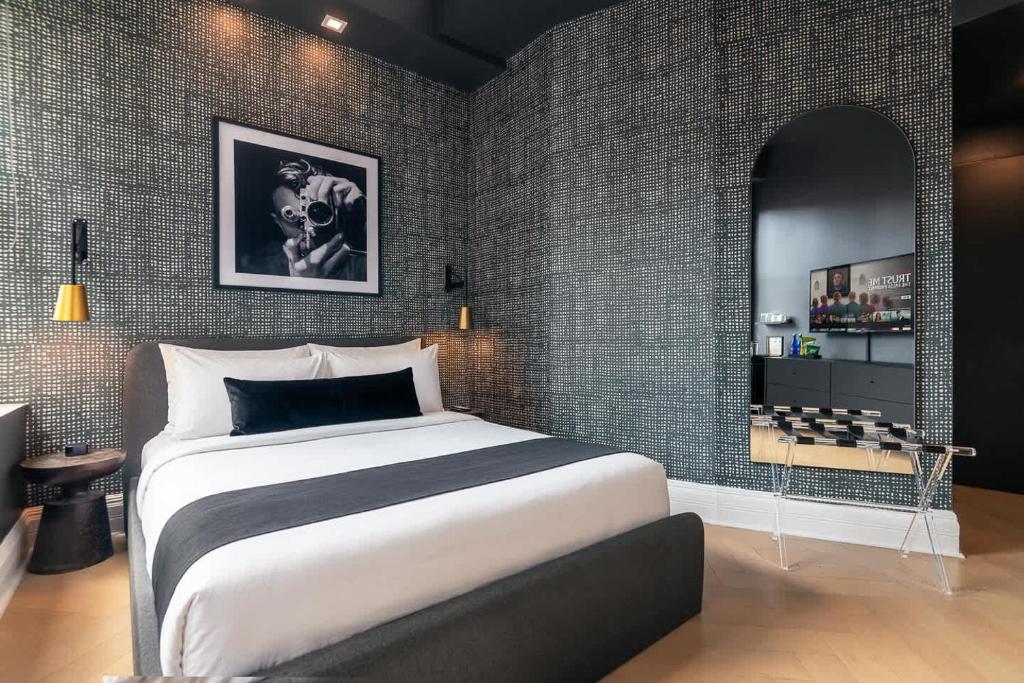 a bedroom with a large bed and a wall with bricks at Madison Square Studio at Return Policy Broadway in New York