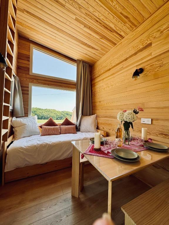 a bedroom with a bed and a table with plates on it at l'échappée verte in Anvéville