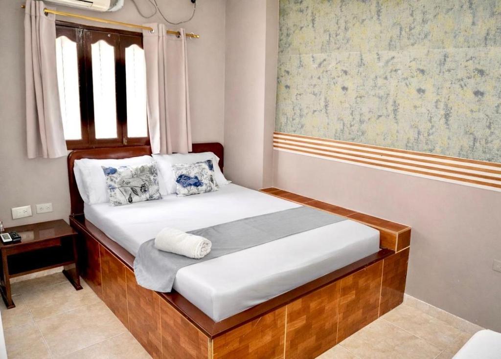 a small bedroom with a bed in a room at Hotel Lua Origenes Rodadero, Santa Marta in Santa Marta